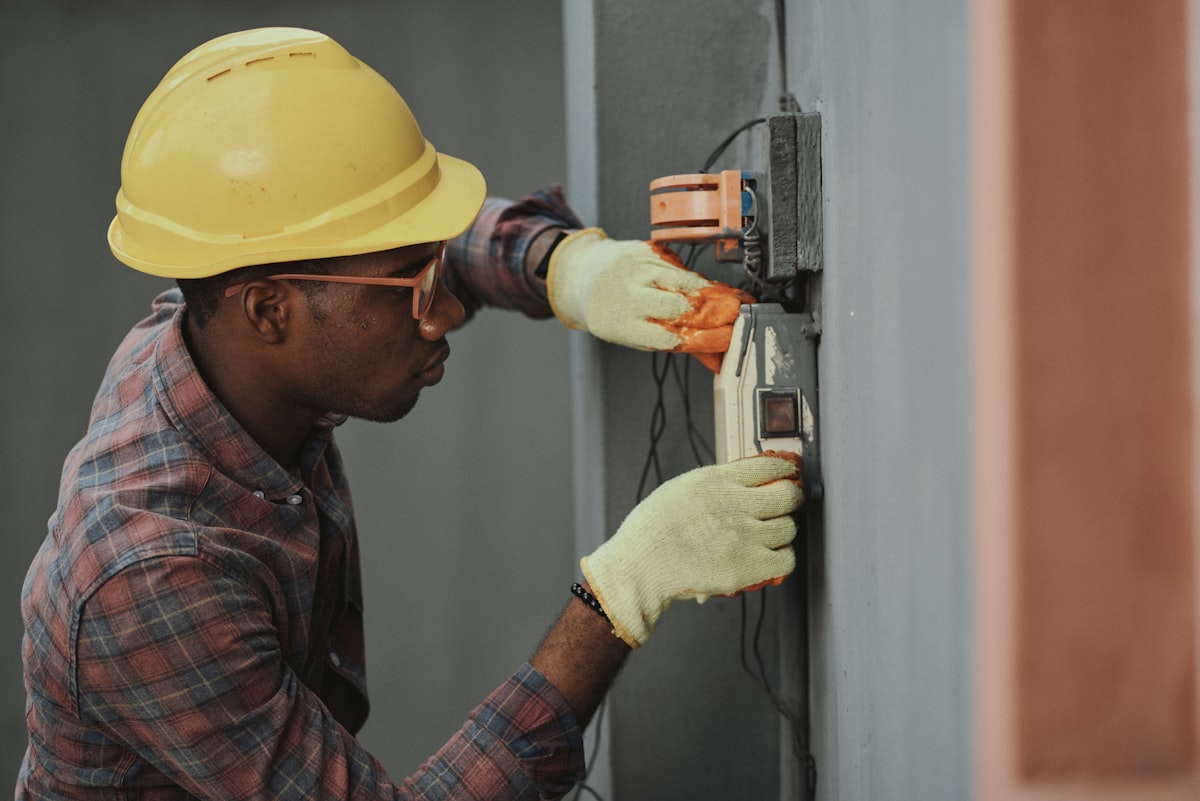 Electrician working at a service panel, stock photograph for the Ridge Electric concept